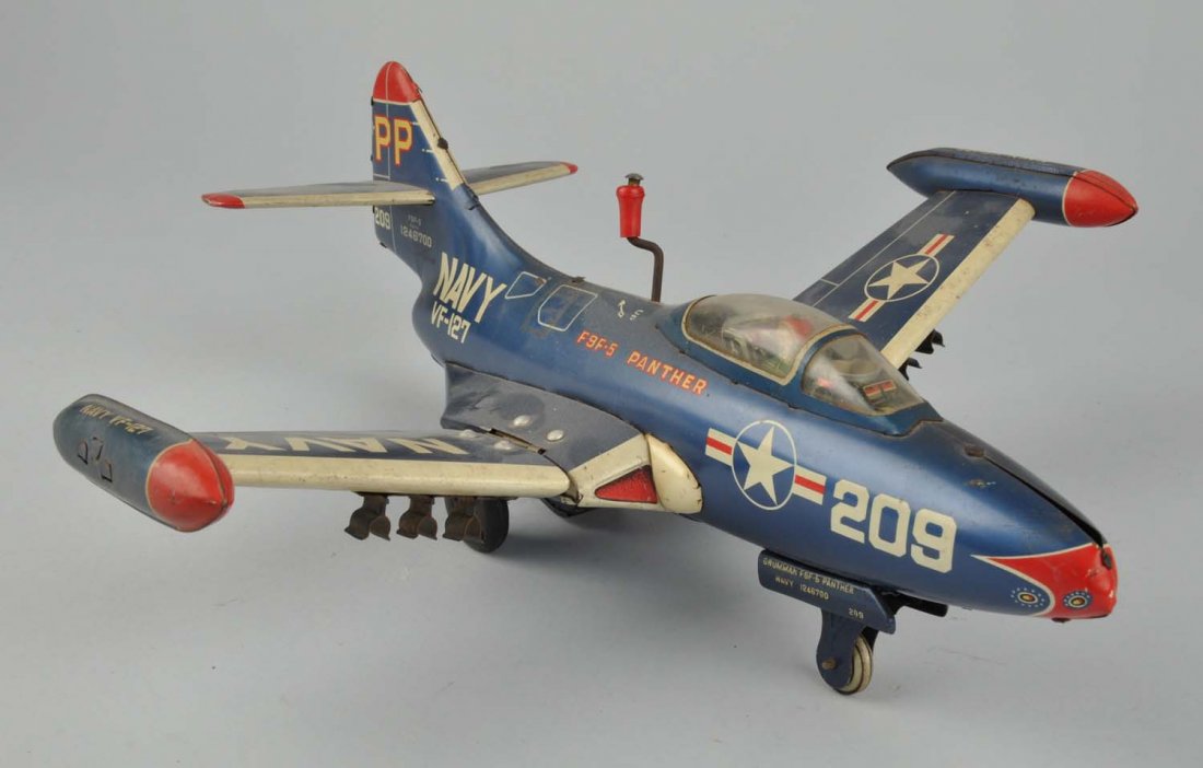 Tin Litho Friction F9F-5 Panther Plane.: Made by Yoni in Japan. Has a few scratches throughout. There is a space for three rockets but they are missing. Plane has its rubber tires in the back and one tin tire in the front. Has original tin s
