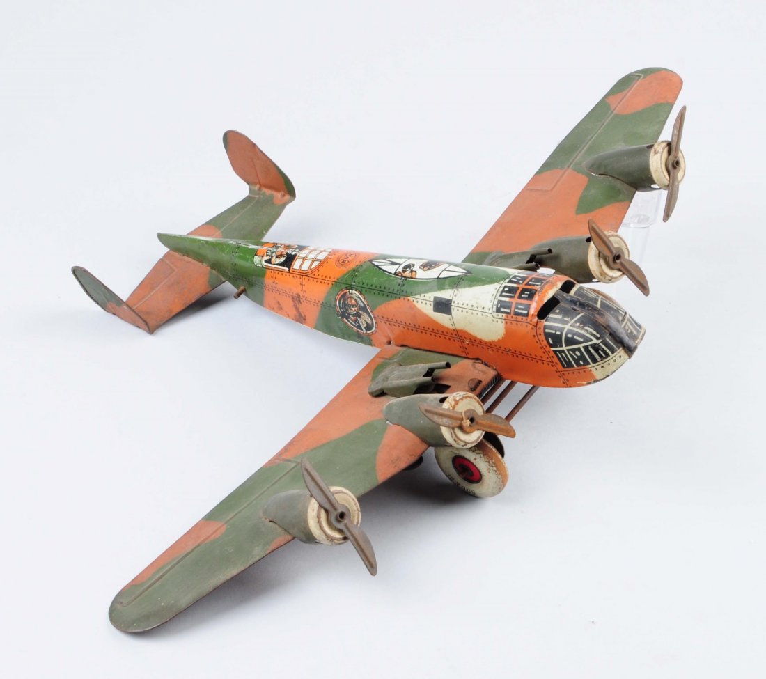 Marx Tin Litho Camouflage Airplane.: Original guns mounted on wing, four motor prop plane, World War II type camouflage. Does have some pitting and oxidation throughout. Condition (Good - Very Good). Size 18x14x4