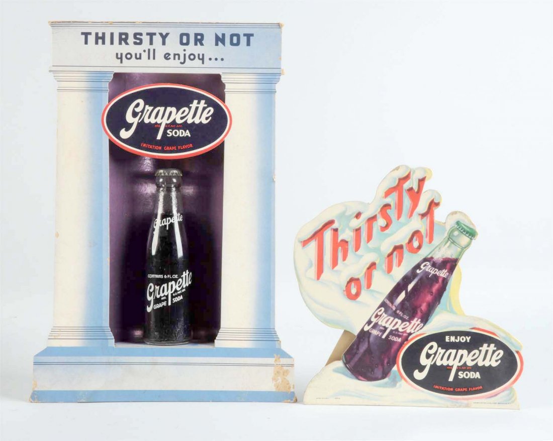 Lot Of 2: Grapette Soda Items.: This lot includes a small easel sign with some edge scraping and a cardboard bottle display with bottle. The bottle display has some loss to the bottom front panel. Still a neat item. Condition (Very 