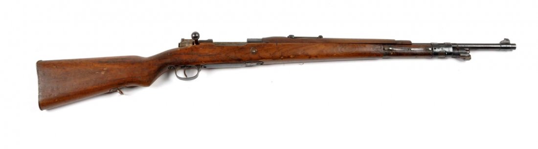 **Spanish La Corona Mauser Military Rifle.: Serial # B3311 Bolt action rifle is chambered for the 7.92mm cartridge. Features a 24" barrel, blued finish, hardwood stock and straight pull. Bridge is dated 1945 with crest. Matching numbers on fram