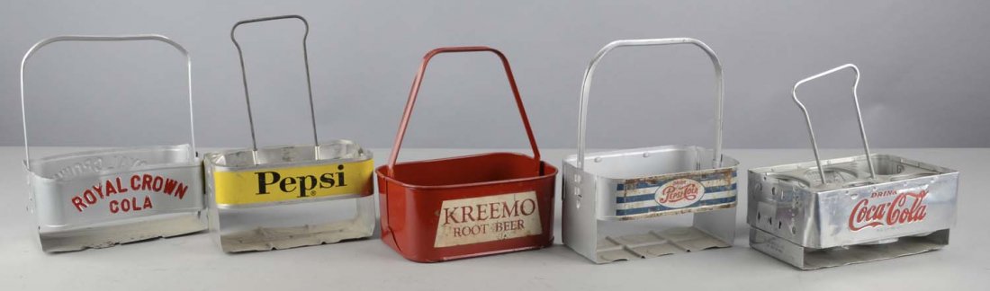 Lot of 5: Six-Pack Soda Carriers: Five metal six-pack carriers for various sodas. 1 - Coca Cola carrier with impressed logo, 1 - Kreemo Root Beer carrier, 1 - Royal Crown Cola carrier with embossed lettering, and 2 - Pepsi Cola carrie