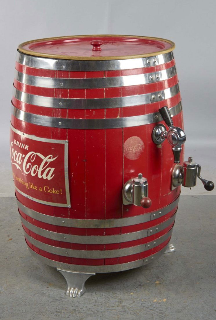 Barrel Coca-Cola Soda Dispenser: Dispenser has three spigots featuring Coca-Cola and root beer. Barrel is supported by three claw foot legs, and has a tin litho reading, "Coca-Cola, There's nothing like a Coke." Condition (Excellent)