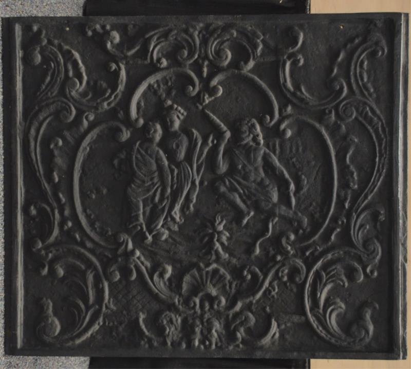 Lot Of 2: Cast Iron Fireplace Firebacks: Including 1 - with ornate scene and design and 1 - reproduction of Colonial Williamsburg fireback, marked Virg.A 1737 on front and stamped with Virginia Metalcrafters and Colonial Williamsburg marks o