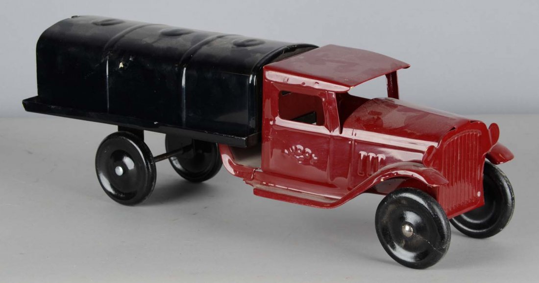 Pressed Steel Buddy L Oil Tanker Truck: Restored in red and black, this toy truck features four black tires and faux headlights. In excellent condition, showing very little wear and great shine to the paint. Cab doors are embossed "Buddy L"