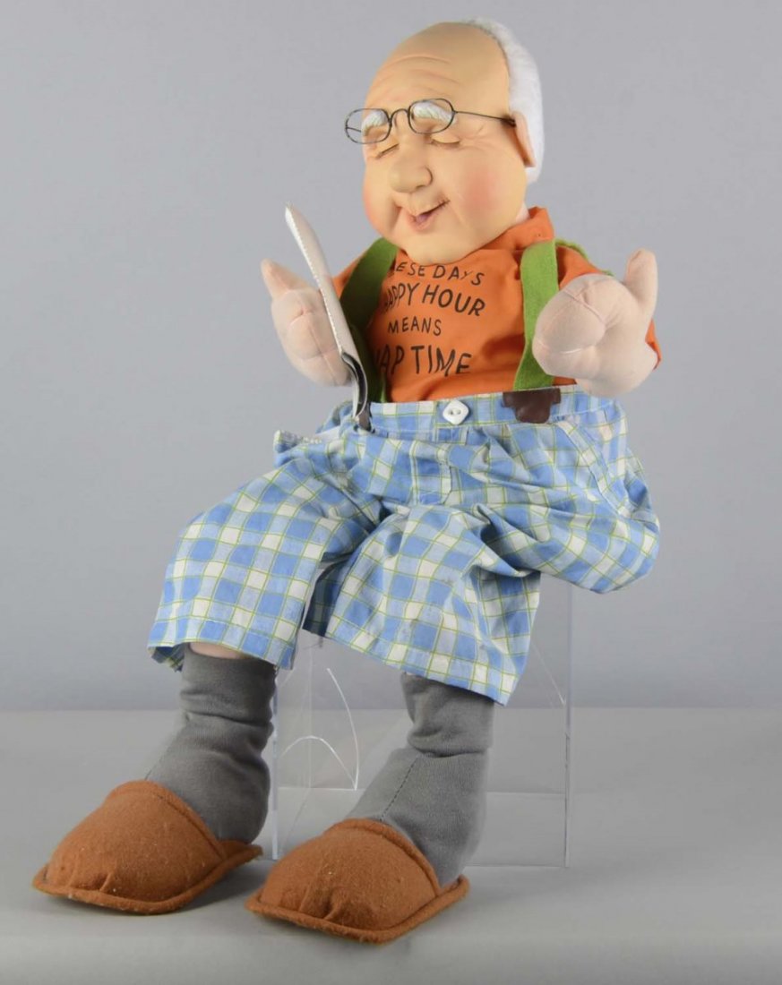 Comical Snoring Old Man Doll: Has battery-operated switch and speaker in pocket to enable him to audibly "snore". This elderly man is made of composition materials and has suspenders, plaid pants, slippers, glasses, and a newspape