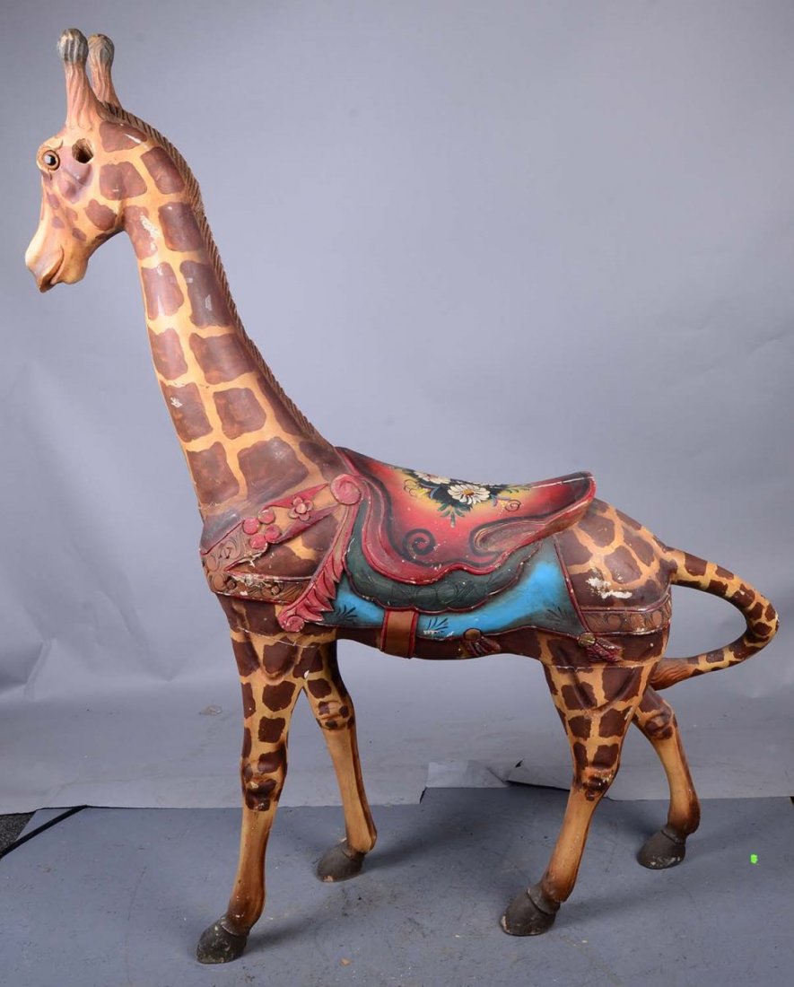 Tall Painted Wooden Giraffe With Saddle: This carved wood giraffe is missing both ears. Came from a movie prop house. Was used in "The L Word" in 2003. Condition (Good). Size 45" x 14" x 66"