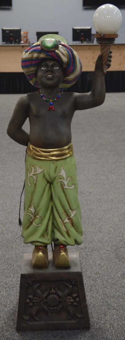 Egyptian Boy Statue Left Arm Holding Lamp Prop: This is a contemporary statue of a boy on stand wearing a jeweled necklace, turban and genie shoes. Came from a movie prop house and used in "Supernatural 5" and "Mr. Young". Condition (Excellent). Si