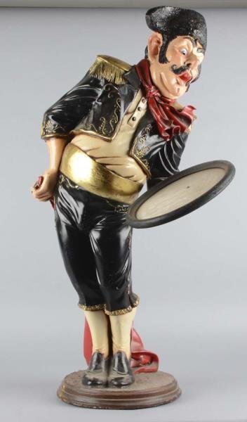 Bullfighter Waiter Holding A Tray: This is a contemporary figural statuette. Has a crack on rear facing arm. Made of a hollow plastic fiberglass material. Came from a movie prop house. Condition (Good). Size 20" x 16" x 38"