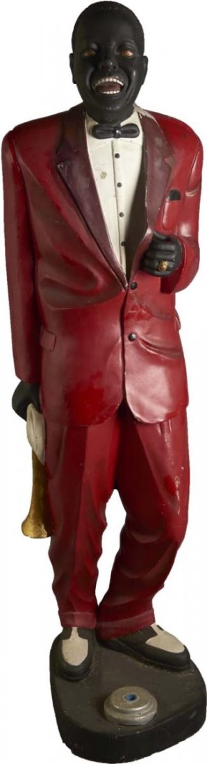 African American Male Jazz Performer Statue: This contemporary statue has the likeness of Louis Armstrong with trumpet and handkerchief motif. Includes U.S.A. Flag on shaft. Shows occasional surface wear. Made of a hollow plastic resin fiberglas