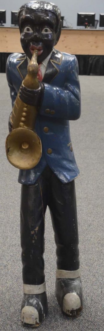 African American Saxophone Player Statue: Made of carved wood. Has some repairs and seam splits. Came from a movie prop house. This is a contemporary piece. Condition (Good). Size 62" T.