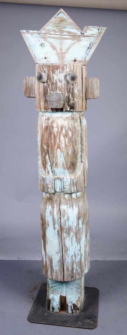 Wood Native American Totem Figure: Wood has dried and only a few areas of turquoise paint remain. This very simple totem shows eyes, mouth, ears, arms, and feet of a man with a triangular headdress. Condition (Good). Size 74" Tall