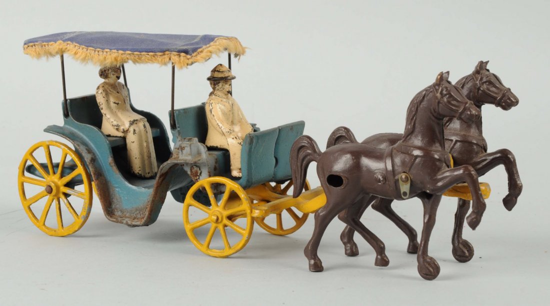 Stanley Toys Cast Iron Horse & Buggy With Riders.: Original canvas rod with tassels. Has some minor paint wear and some rust on the right side of the carriage. Displays great. Condition (Very Good - Excellent). Size 12'' L.