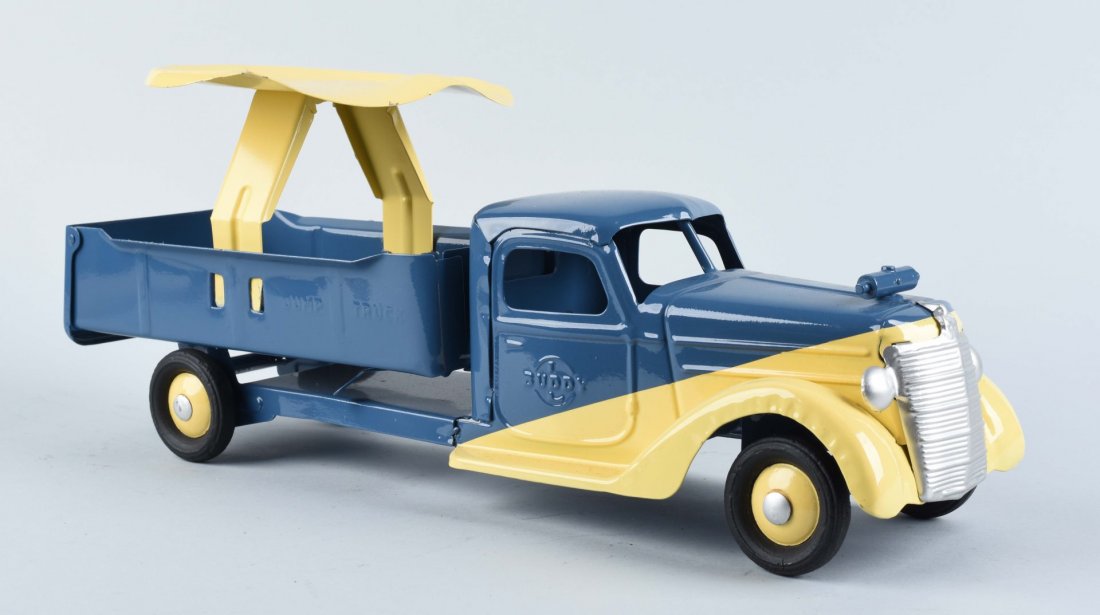 Buddy L Ride On Pressed Steel Truck.: This ride on Buddy L truck is nicely restored. Painted in blue in yellow. Condition (Excellent). Size 20 - 1/2" L.