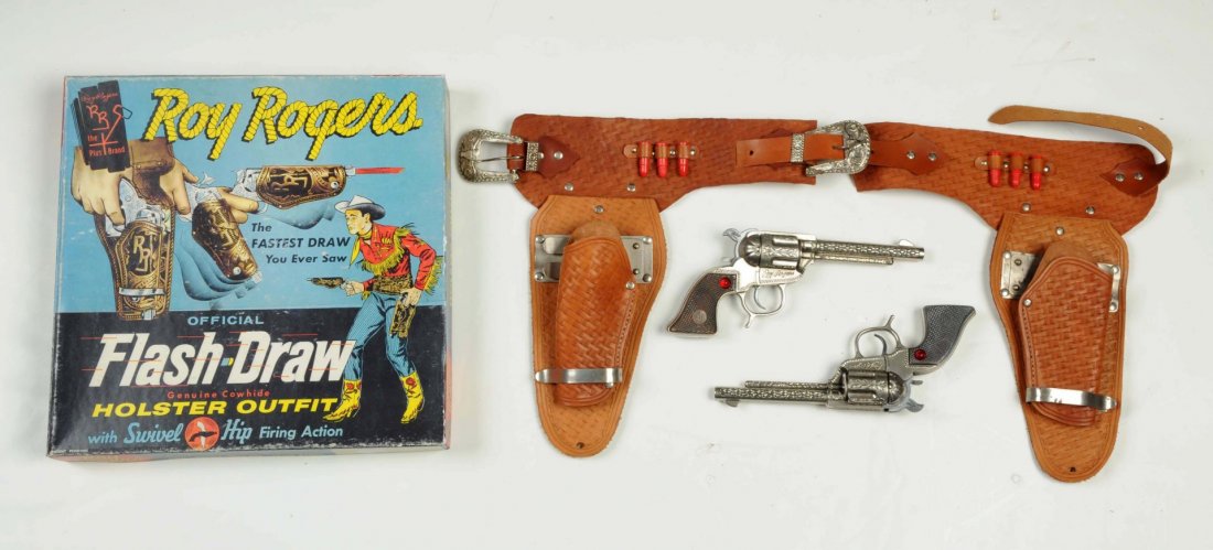 Roy Rogers Flash Draw Gun & Holster Set.: Schmitd guns have been reconditioned around the hammer areas. Scarcer guns have the red jewels. Holster is the trick style flash draw. (Guns: Excellent - Holster: Excellent - Near Mint - Box: Very Goo