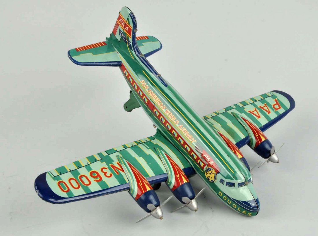 Japanese Tin Litho Friction Douglas DC 7 Airplane. (1 of 3)