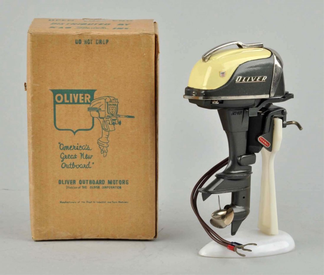 Very Scarce Japanese Oliver Outboard Toy Motor.: Nice two-tone green and cream. Original boat stand. Original box with insert and instructions. Very little wear. Condition (Excellent - Near Mint). Size Box: 6" x 3 - 3/4".