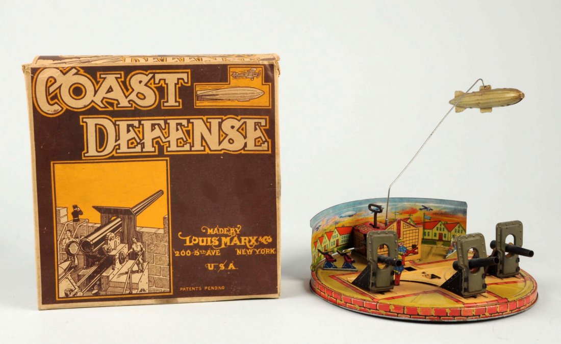 Marx Tin Litho Wind-Up Coast Defense Toy.: World War I type litho. Includes very tough original box showing soldiers operating big gun. Box is complete except one small inside flap is missing. Some tearing and creasing to top lid, otherwise bo
