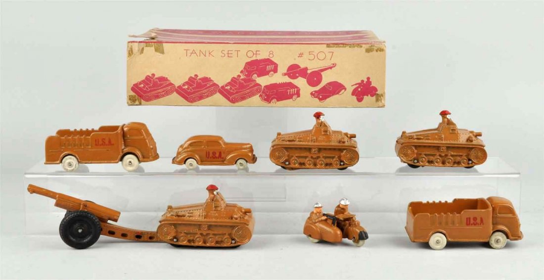 Scarce Auburn Rubber Military Toy Set.: Includes original box marked "Tank Set of 8 No. 507". Includes original box, which has original inserts. Also includes motorcycle and side car, three jeeps, an automobile, a truck and a howitzer gun. 