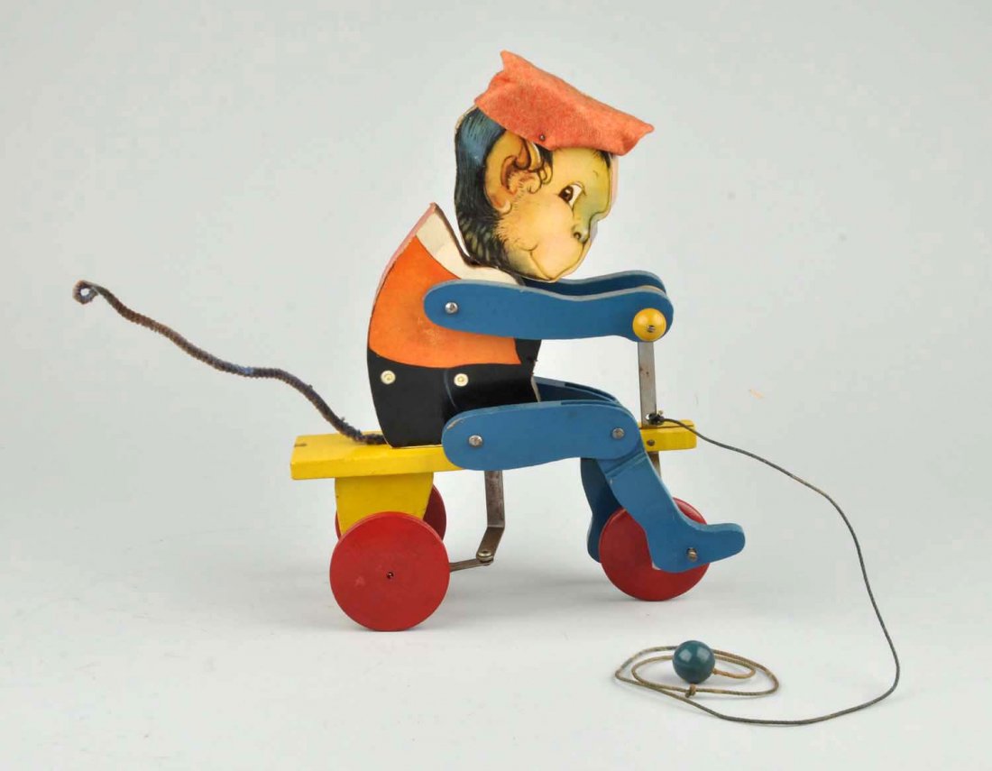 1931 Fisher-Price Paper On Wood Lookee Monk Toy.: Very difficult to find. Has original felt tail. Original hat is missing tassel. Very scarce piece with minor to moderate staining on left side. Condition (Excellent). Size 11-1/2'' T.