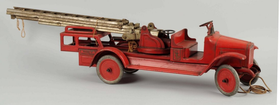 Buddy L Hydraulic Aerial Ladder Truck.: Circa 1920's. Pressed steel. Original decals, ladders, pull cord, and paint. Could clean to a better grade. Condition (Very Good). Size 40'' L.