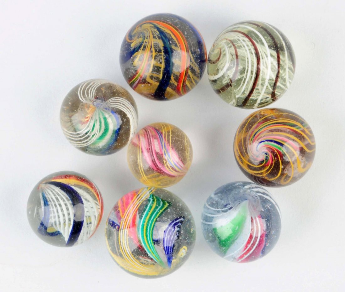 Lot Of 8: Swirl Marbles.: Lot includes multi color latticino and divided core swirls with nice surface conditions. Condition (9.2 - 9.6). Size 1" - 1 - 13/32" Dia.