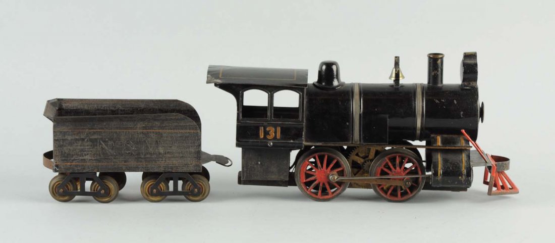 Carlisle & Finch Locomotive No. 131 & Tender.: Engine embossed 131 tender emboss N&M. and is made of tin with wood flooring. Engine has slight creasing and paint chipping to cab roof. Tender has more overall paint scratching and wear. (Engine Exce