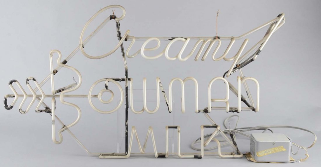 Creamy Bowman Milk Advertising Neon Sign: Electric sign on glass tube frame with bow and arrow logo in neon. Includes a separate transformer. Circa 1950s. Condition (Very Good). Size 36" x 22" x 2 "