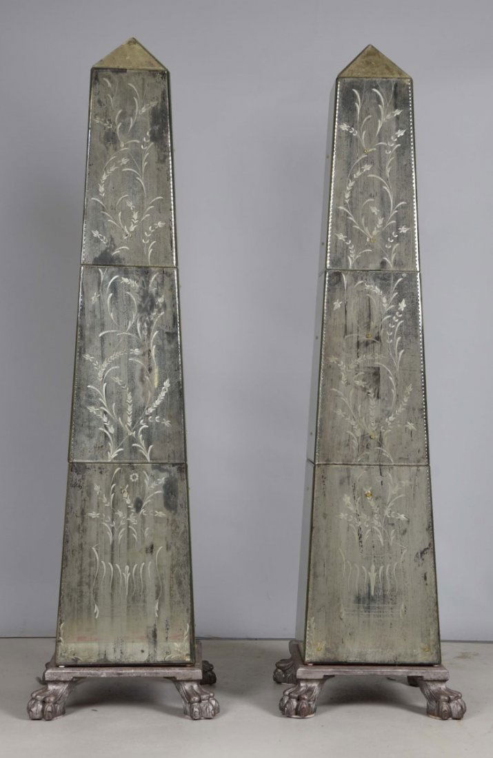 Pair of Monumental Mirrored Obelisks.: Very unique design with decorated and scalloped edge antique mirrors. There are small rosette appliqués on each glass panel as well. There is one broken mirror on the very top. Signed by Albert Maign