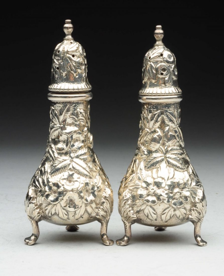 Pair of Kirk Sterling Casters.: Repousse with bulbous bodies, domed lids, and on three pad feet. Height: 4-1/2". Weight: 4.5 ozt web conditions: - signs of use and wear, especially to high points of repousse chasing
