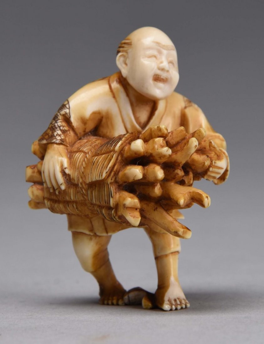 Japanese Ivory Netsuke of Man Holding Roots. (1 of 1)
