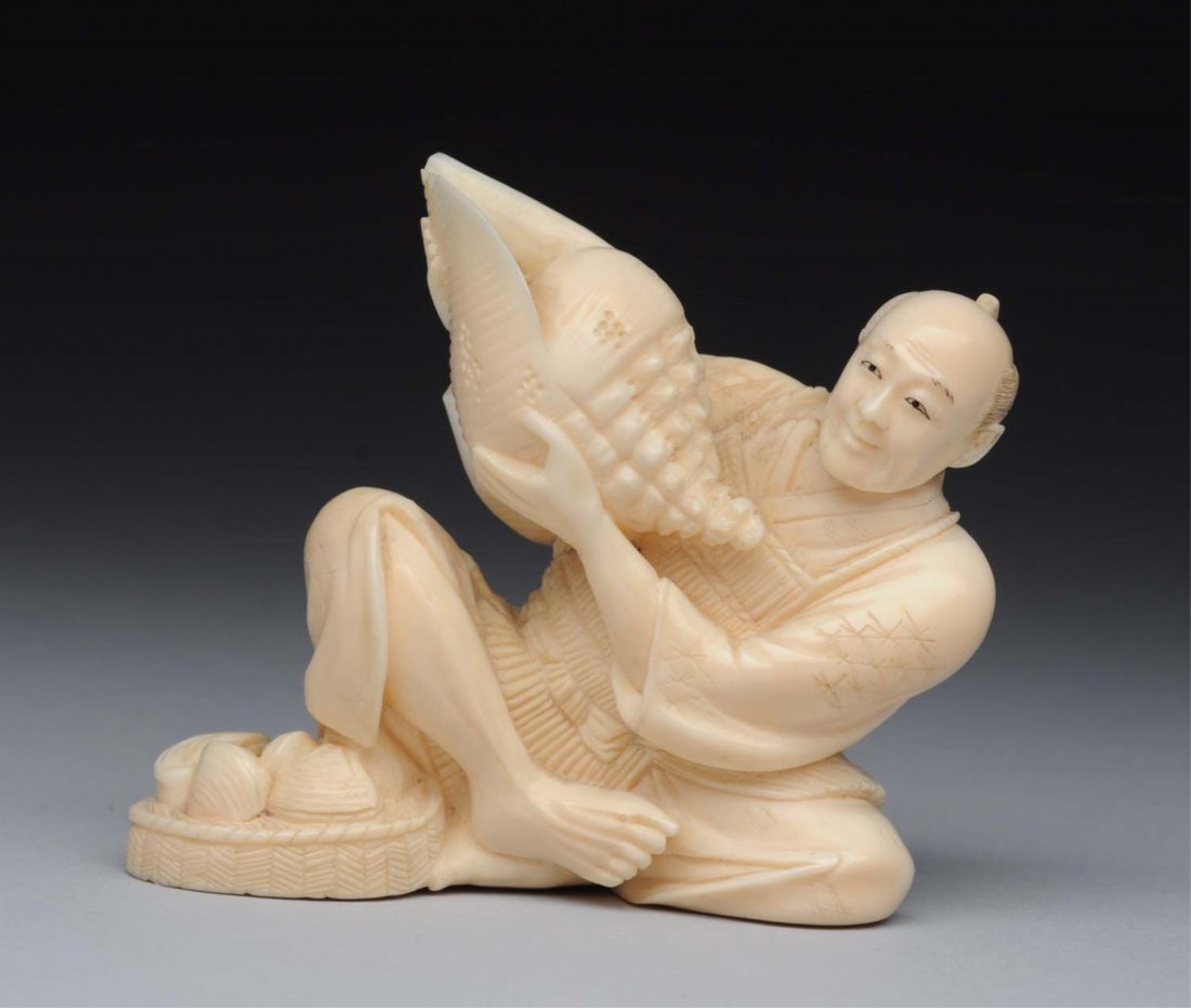 Antique Japanese Ivory Okimono Man with Shells.: Very intricate and well made. Shows a man sitting down holding a large shell. Great shape with minor wear to the top of the shell. Condition (Excellent). Size 2 - 1/2" T.