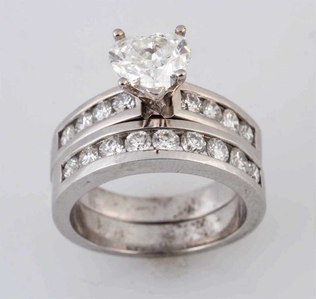 1.29 ct. Heart Shaped Diamond Solitaire.: Center diamond is approximately I color and clarity enhanced. 14K. RBC diamonds approximately 1.25 cts TW. Approximately I, SI. 6.4 dwts. Size 6-3/4.