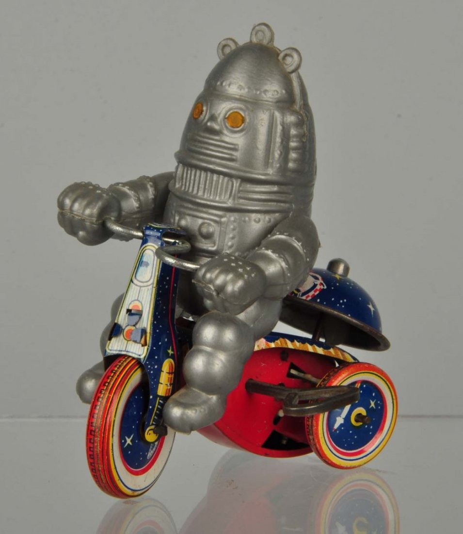 Japanese Robot on Tin Tricycle Toy.: Plastic robot on tin tricycle. Minor wear only. Condition (Excellent). Size 4 - 1/2" T.