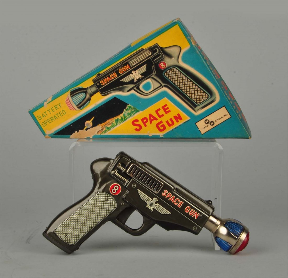 Battery Operated Space Gun In Box.: Very cool gun with colorful box included. Several small areas of loss to box. Condition (Excellent). Size 6 - 1/2" T. x 8" L. x 1 - 1/2" D.
