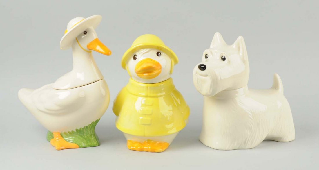 Lot Of 3: Metlox Cookie Jars.: This lot includes a White Scottie Dog, Francine the Duck and Puddles the Duck in a yellow raincoat. No chips, cracks, or crazing. All marked Metlox on the base. Condition (Near Mint). Size Largest: 13