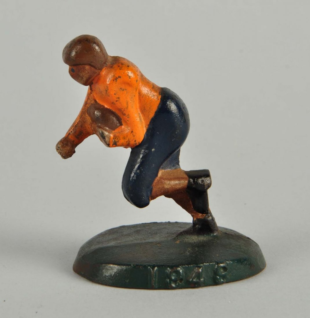 Cast Iron Football Player with Ball Paperweight. (1 of 1)