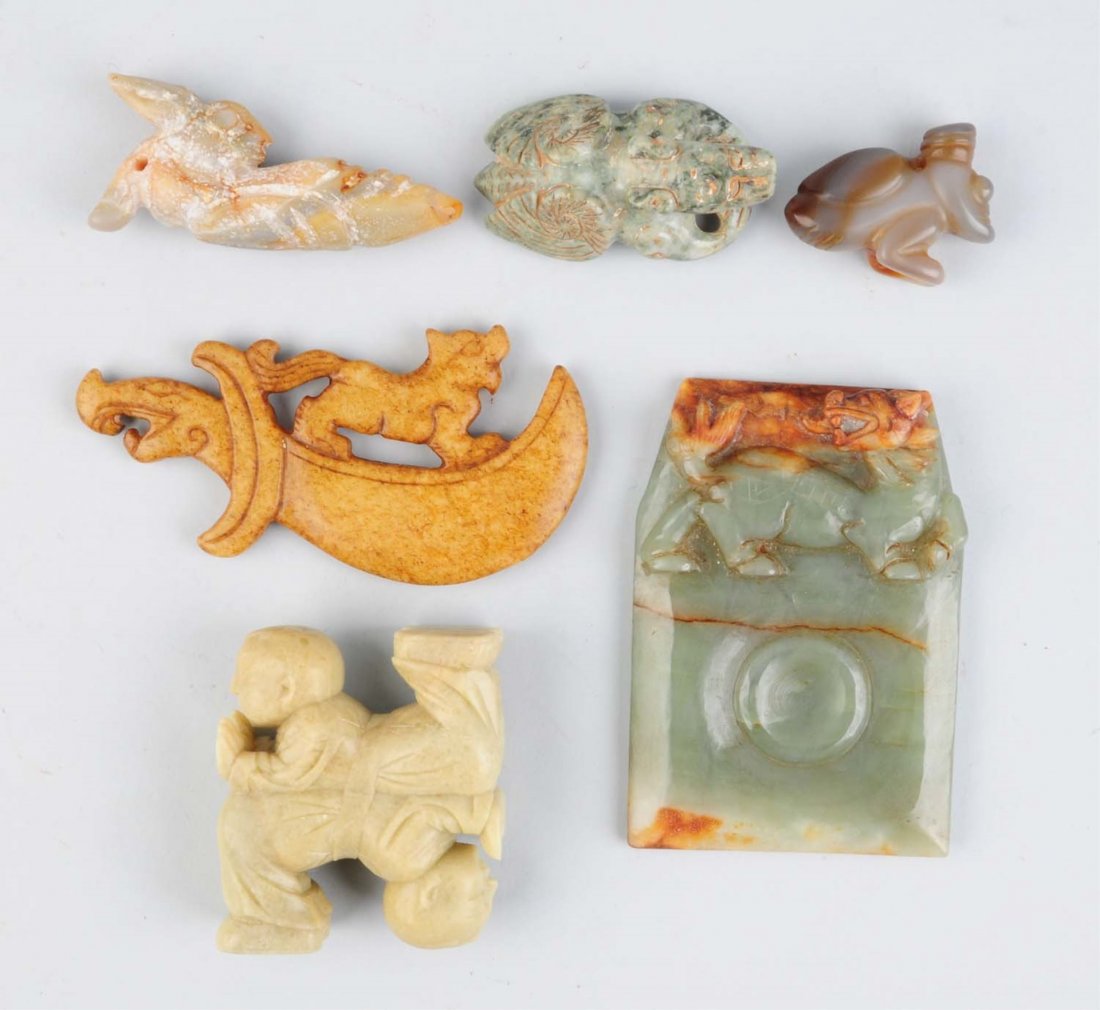 Lot Of 6: Stone Pieces.: 2-1/2” long nose dragon-like creature, a 5” sword with a cat on top. Two boys, one up, one down which is soapstone. A bug with wings on his back in a turban hat, 2” long. A mystery creature with