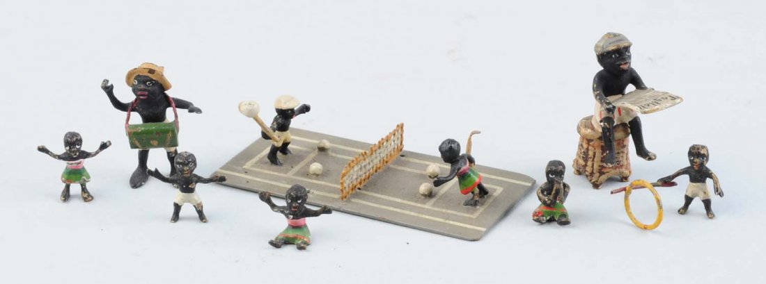 Lot Of 7: Vienna Mini Bronze Pickaninny Figures.: A boy and girl playing tennis, a boy sitting on a stool reading a newspaper, a boy playing with a hoop, and others. Several tiny figures, measuring a 1/2" of the smallest and 2" for the largest. Nicel