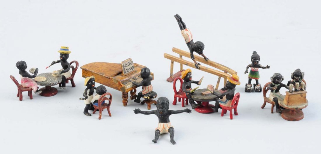 Lot Of 8: Vienna Mini Bronze Pickaninny Figures.: Boy on parallel bars, boy playing piano, boy and girl at table having coffee, two girls with headphones at telephone operators desk, two boys with straw hats playing cards at table, 1 boy shaving othe