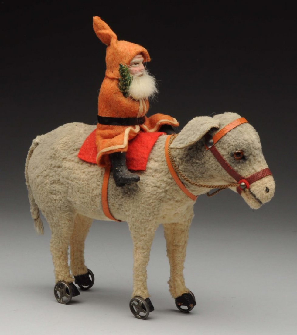 Santa on Candy Container Donkey.: Papier-mâché seated Santa Claus riding a wool covered donkey with glass eyes and removable head to store candy. On small rolling wheels. Wool to donkey is somewhat discolored and worn. Condition (Go