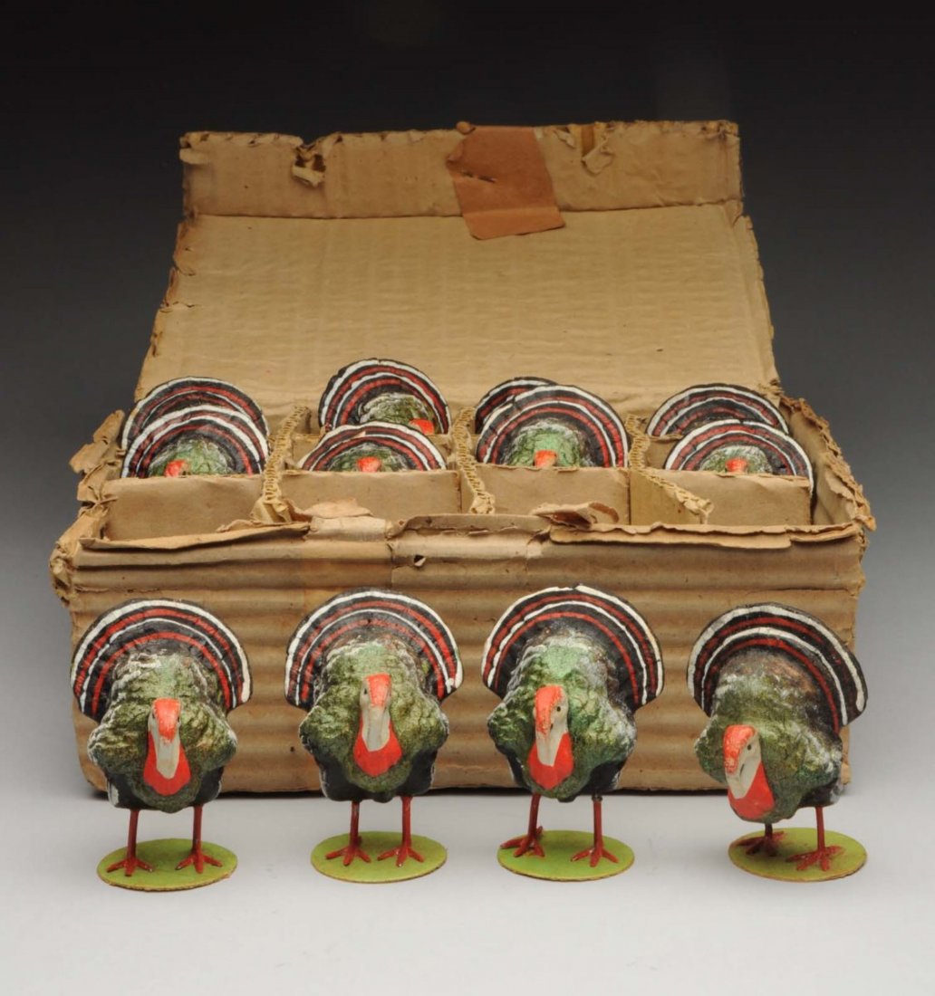 Lot of 12: Boxed Turkey Gobblers.: 12 papier-mâché painted turkeys with metal legs on cardboard flat bases, stamped "Germany" on bottom. All appear to be in unplayed with condition. Box is worn but has the original paper label on the
