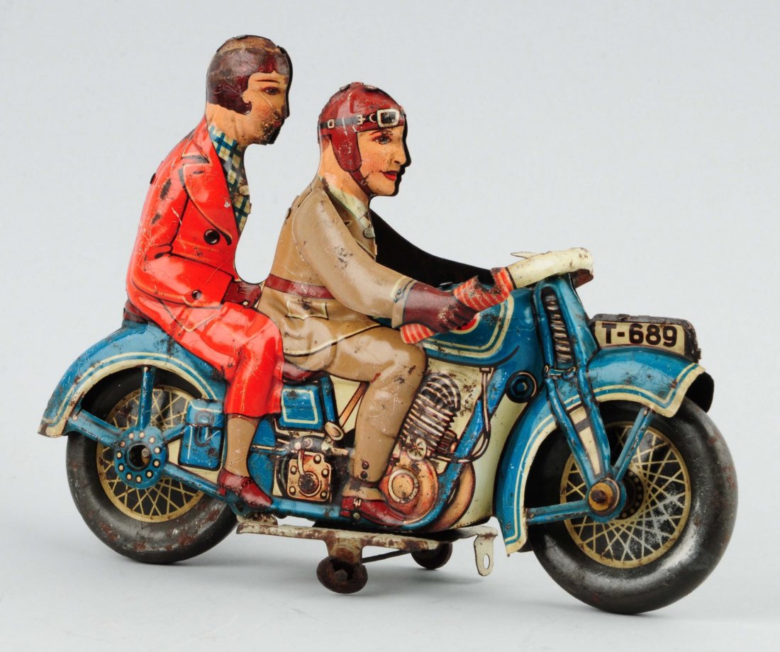 German Tippco Double Rider Motorcycle Toy.: Tin litho wind-up. "Azul T-689" marked on top of front fender. Also has Tippco mark on both sides of gas tank. Could possibly have had headlight which is no longer there. Small piece of tin the size o