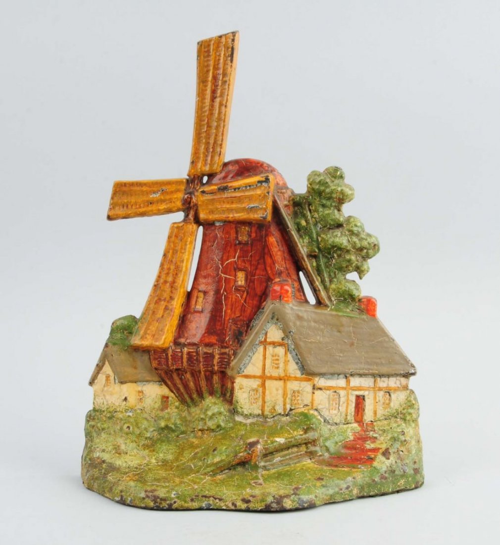 Cast Iron Windmill with Cottages Doorstop. (1 of 3)