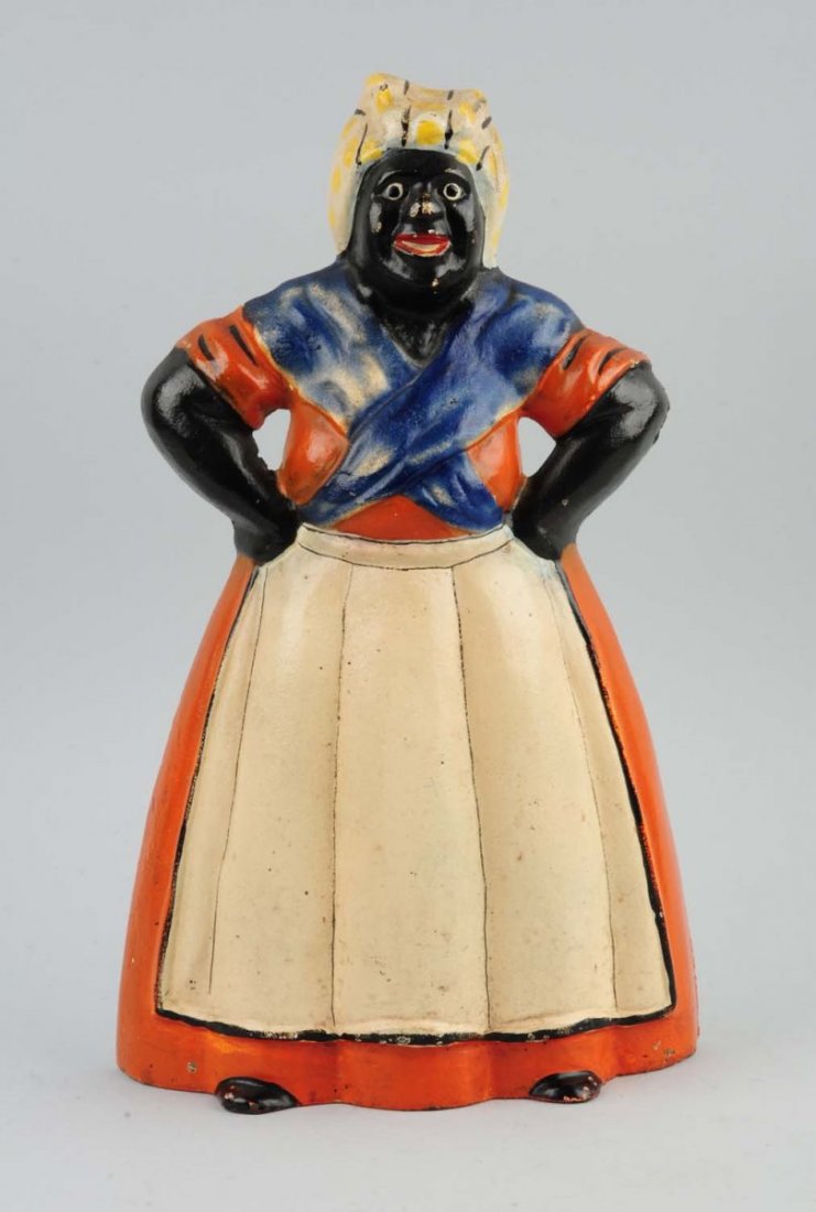 Cast Iron Mammy w/ Hands on Hips Doorstop.: Made by Littco. Typical pose of mammy wearing bandana and apron, with hands on hips. Rare color variation. Condition (Excellent Plus). Size 13'' T.