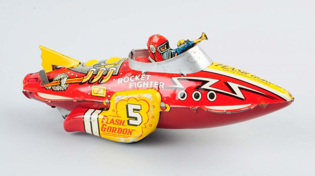 Marx Tin Litho Wind Up Flash Gordon Rocket.: Looks to have original tail fin. Needs flint to spark. Slight bending to gun. Marked "Flash Gordon" to sides and front. Some litho loss to side fins and some scratching overall. Under rocket has had s