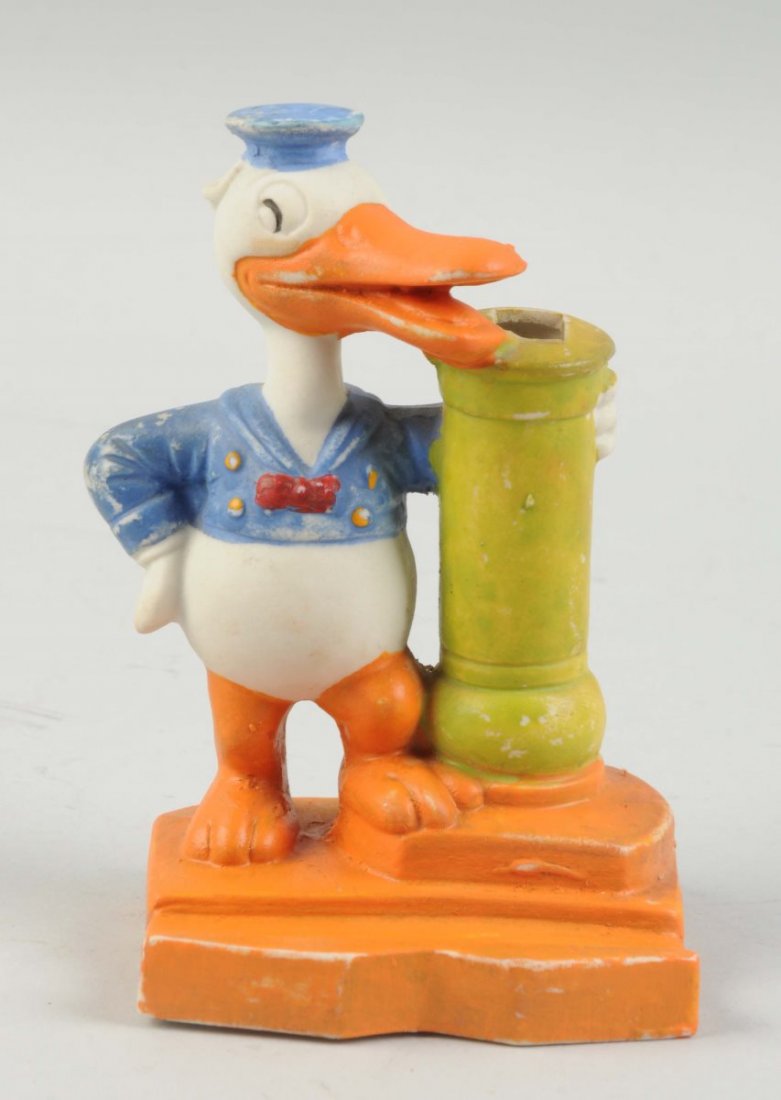 Japanese Bisque Donald Duck Toothbrush Holder.: Scarce single tooth brush version. Nice depiction of early Donald Duck. Marked "Walt Disney" on back. Some general wear to front, hat, beak, back of figure. About a 1" flaw mark underneath base. Condi