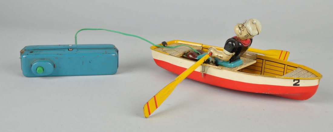 Jap. Linemar Tin Litho Popeye and Rowboat Toy: Complete with original oars, original remote but wire has been replaced. Works well. Rubber pipe. Some scratching and wear mainly to remote. Condition (Very Good). Size 11 - 1/2" L.