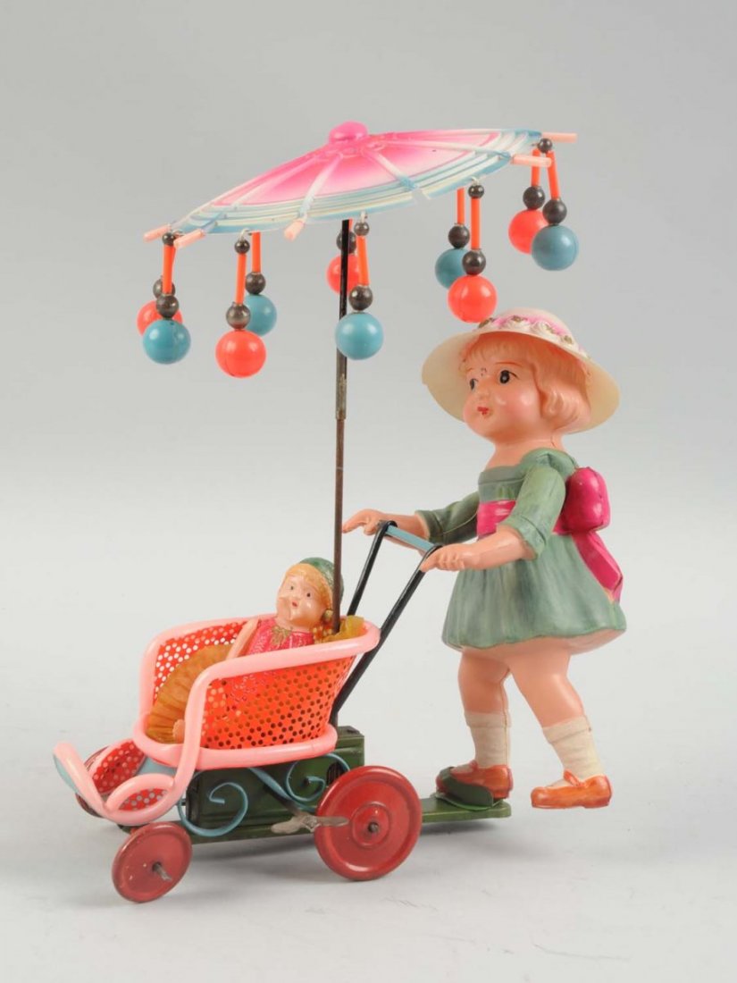 Japanese Celluloid Wind Up Woman Pushing Stroller. (1 of 2)