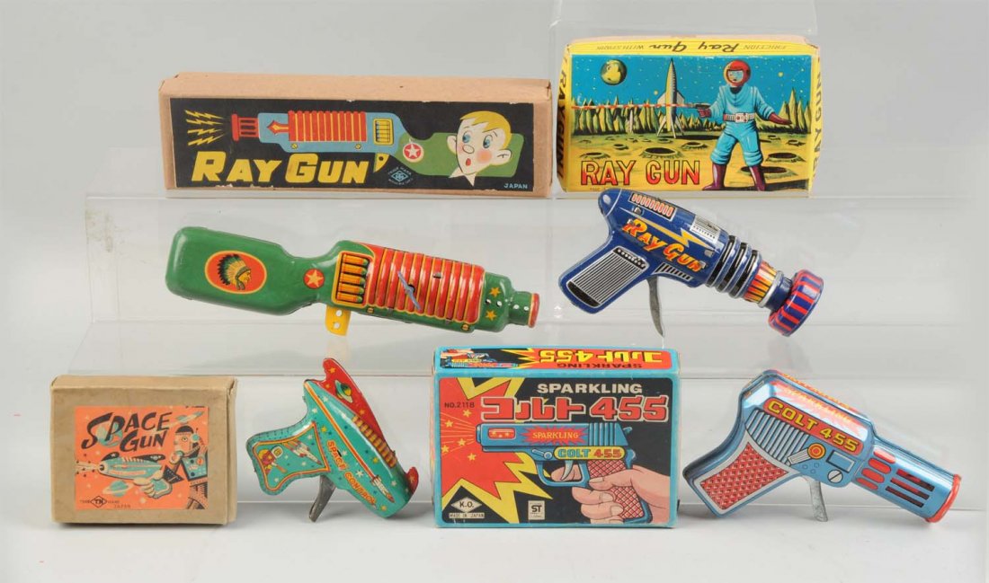 Lot Of 4: Japanese Space Guns In Boxes.: Friction and wind-up Space guns. All in original boxes with nice color graphics. A wind-up ray gun, a friction ray gun, a friction space gun and a friction sparkling 455 Colt gun. Various makers. Orig