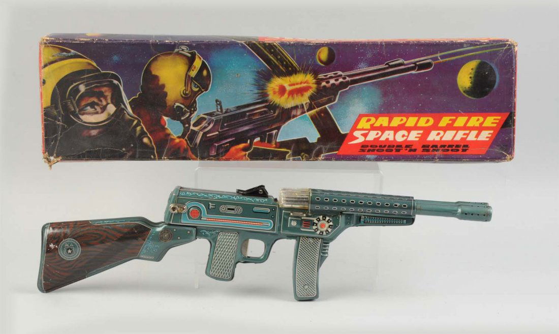 Tin Litho Rapid Fire Space Rifle In Box.: Battery operated. Original box with very nice colorful graphics of gun being fired. Box does have some creasing and moderate wear. Unmarked but probably Japanese. Gun is mostly tin litho. Gun does hav